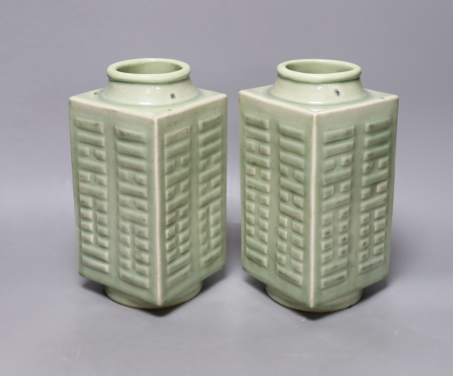 A pair of early 20th century Chinese celadon glazed eight trigrams cong vases, 25cm